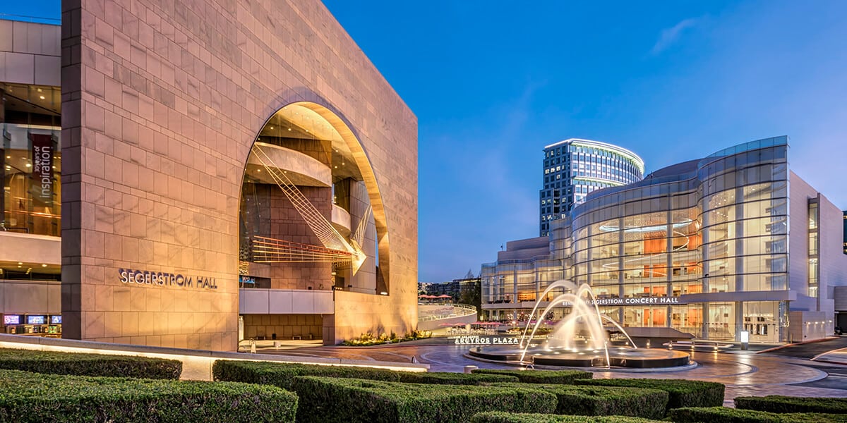 Exterior view of the Segerstrom Center for the Arts, showcasing its modern architectural design and surrounding landscape.