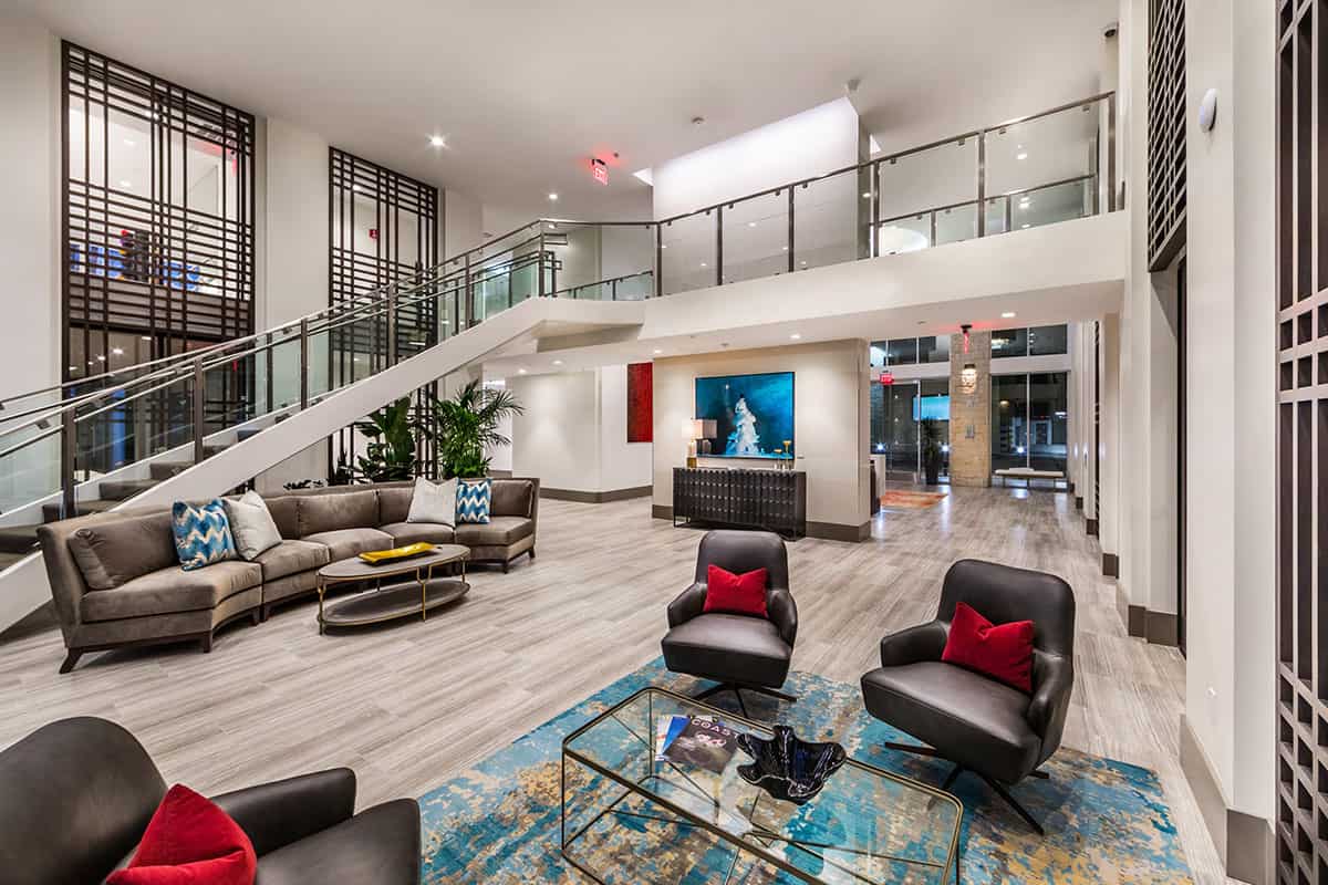 Elegant lobby seating area at 580 Anton, furnished with comfortable chairs and tables, creating a welcoming and sophisticated atmosphere for residents and visitors.