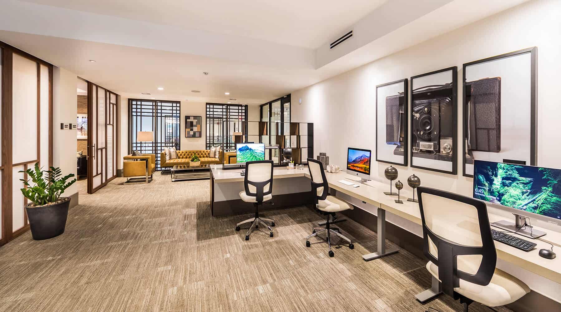 Office space with two workstations, a sofa, and modern decor.