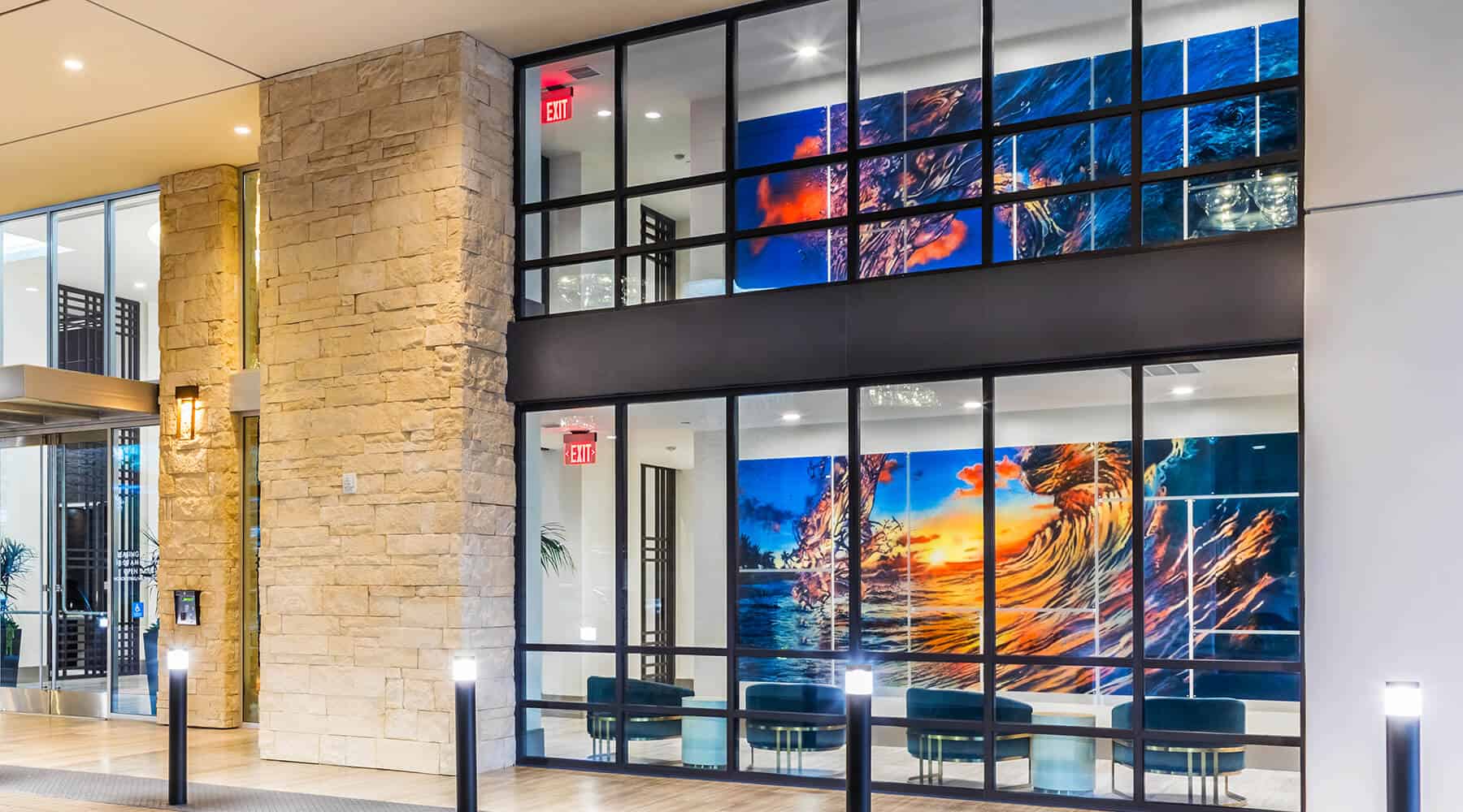 Exterior of 580 Anton with modern lighting, large windows, and vibrant artwork.