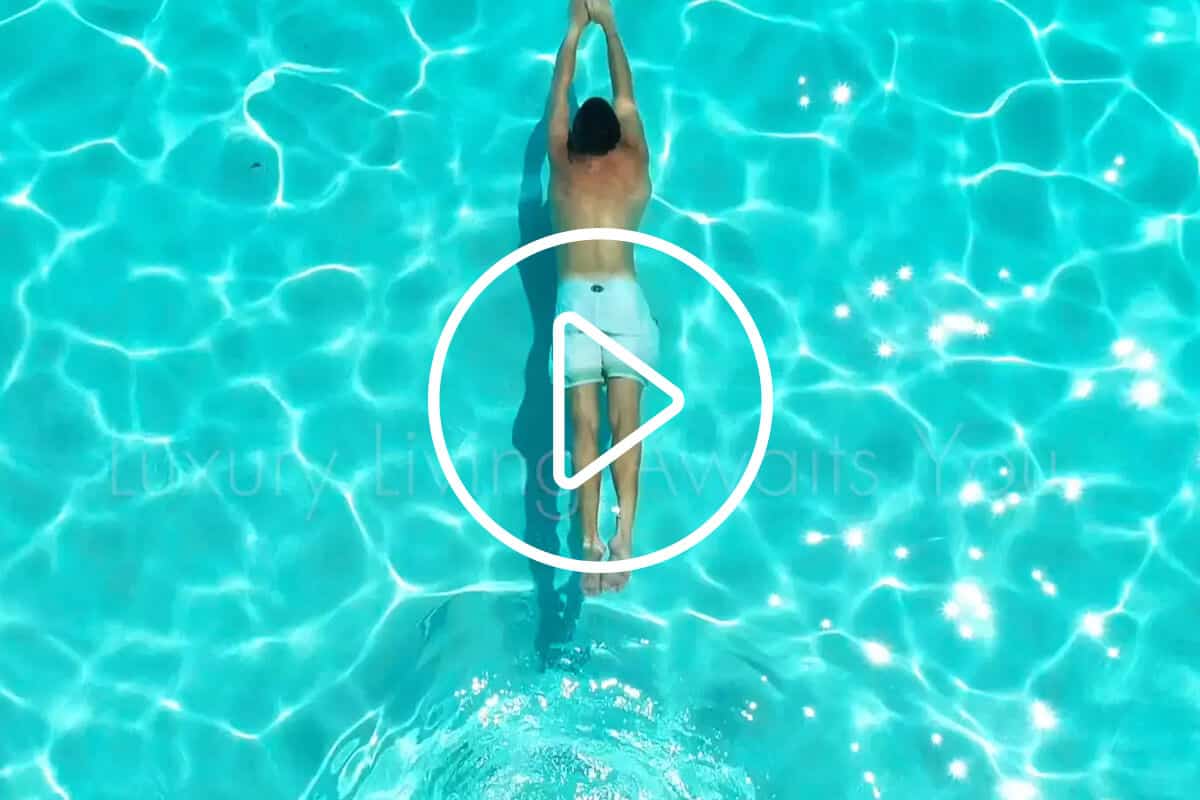Person swimming in a pool with a 'Luxury Living Awaits You' caption.